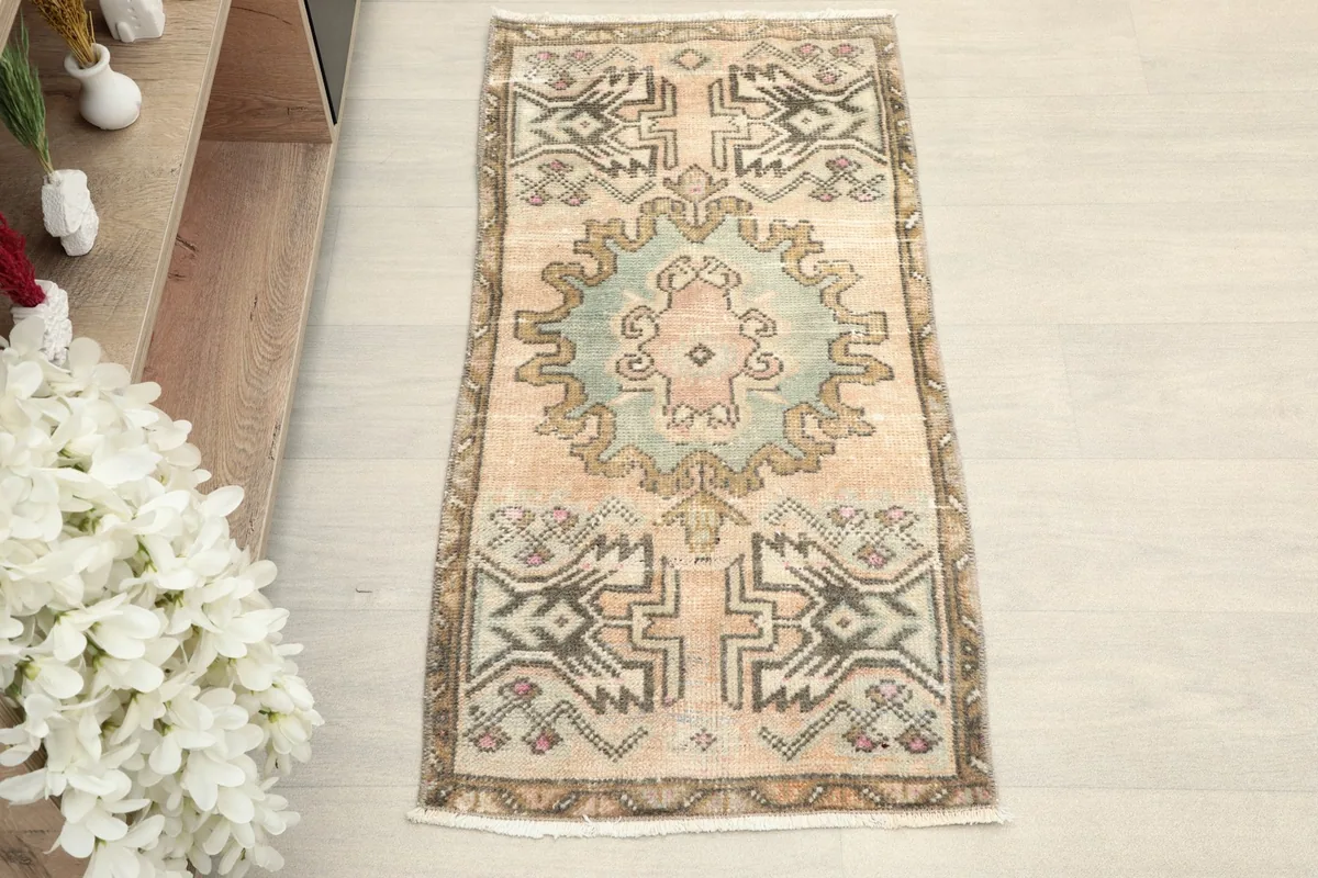 Direct overhead view of the hand-knotted beige and blue vintage Anatolian rug.