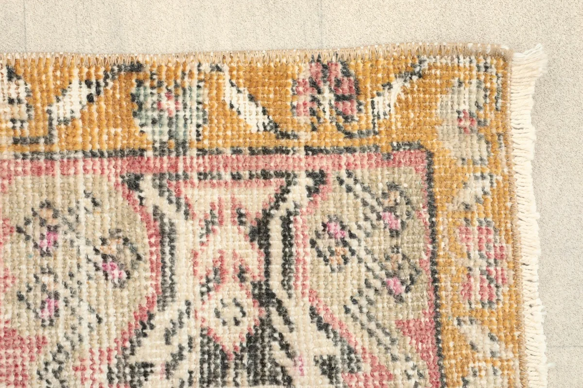 Close-up of the rug's border and a section of the main field, showing the texture and colors.