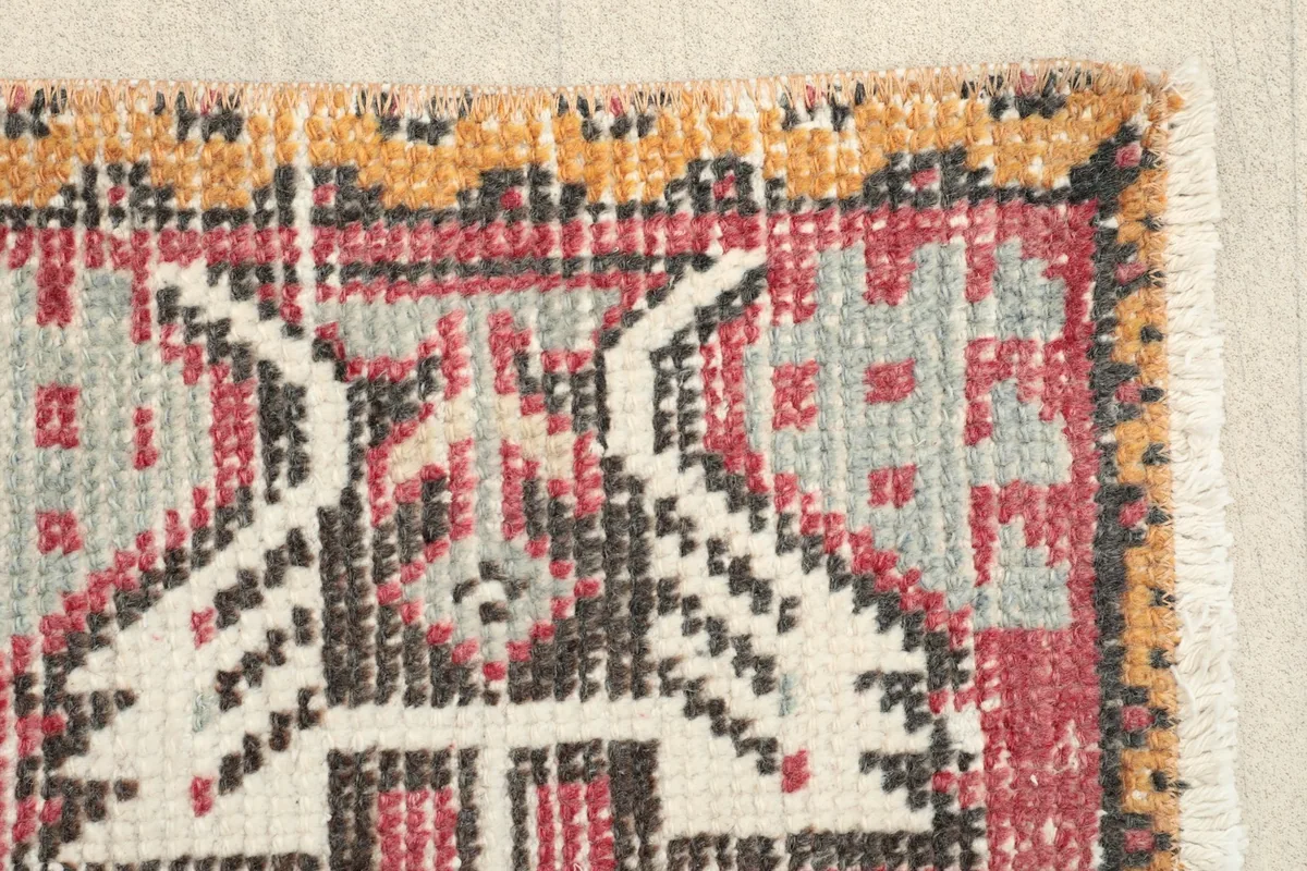 Close-up of the rug's border and a section of the main field, highlighting the hand-knotted texture.