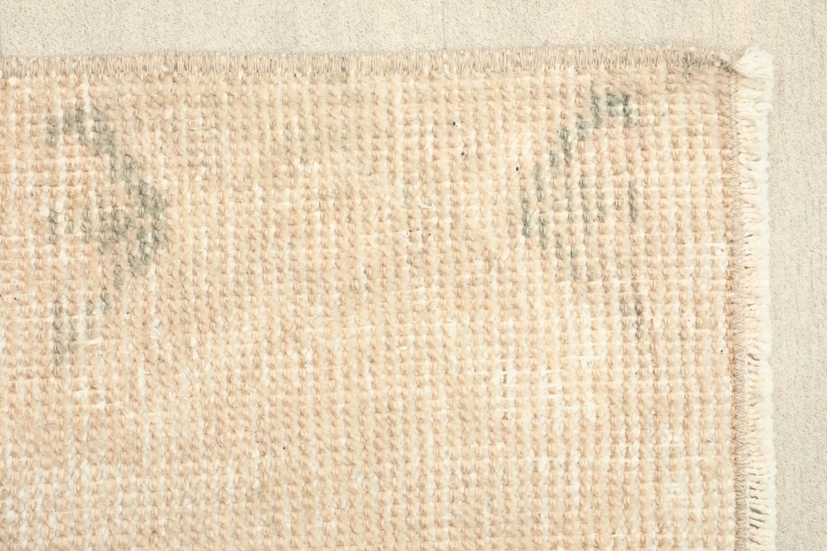 Detail of the back of the rug, showing the consistent knotting and original fringe