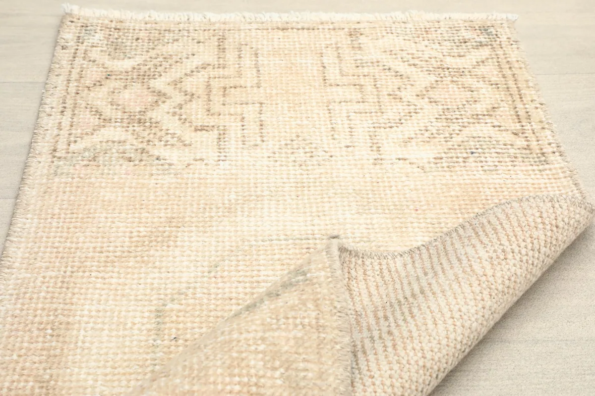Partial fold of the rug, illustrating the flexibility and construction of the vintage piece