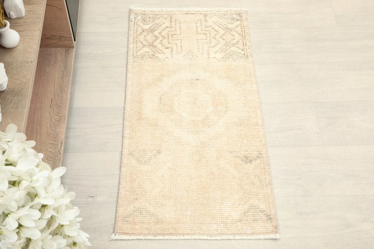 Overhead view showcasing the subtle beige and gray colors and geometric pattern of the rug