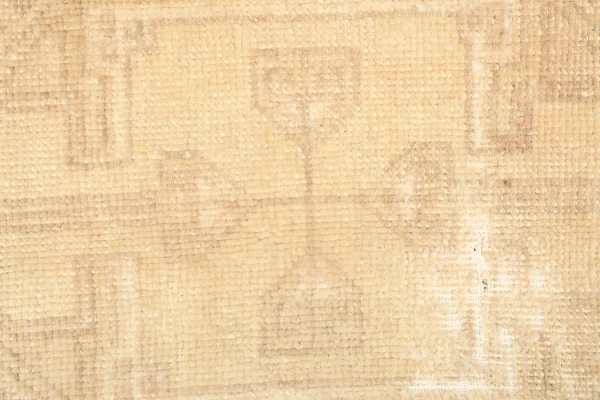 Detailed view of the central tribal motif and texture of the hand-knotted wool pile.