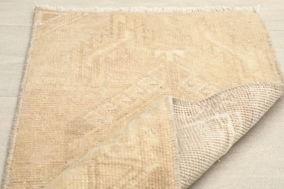 The rug folded back to reveal its underside, highlighting the sturdy cotton foundation.