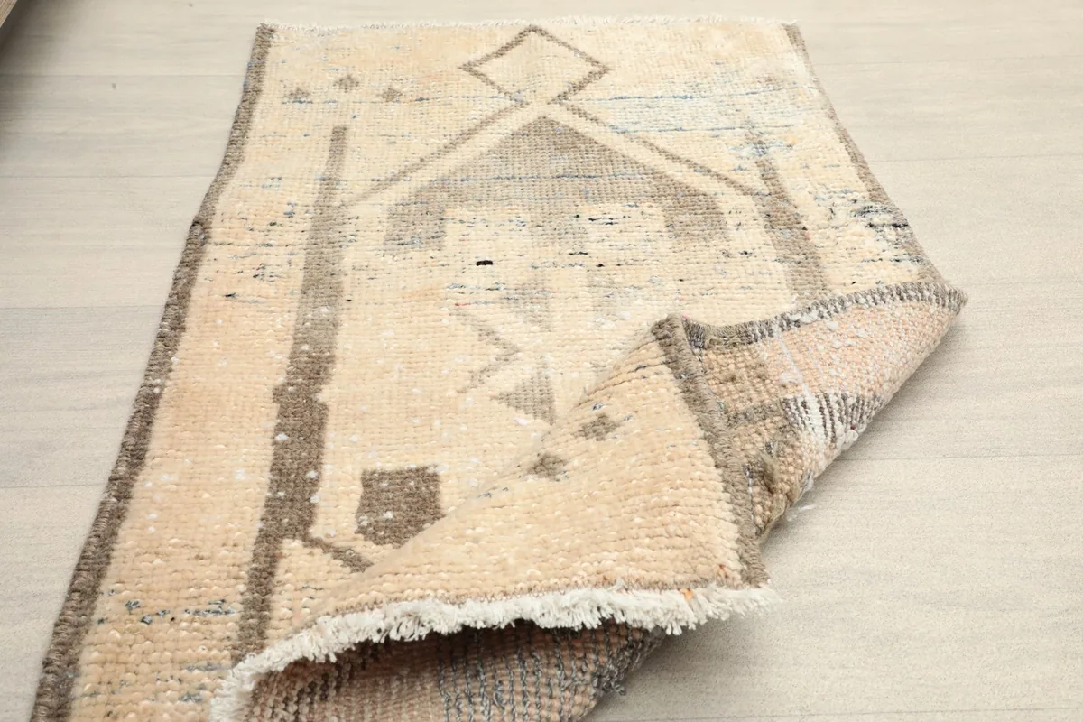 Rug partially folded, displaying its flexibility and the overall design.