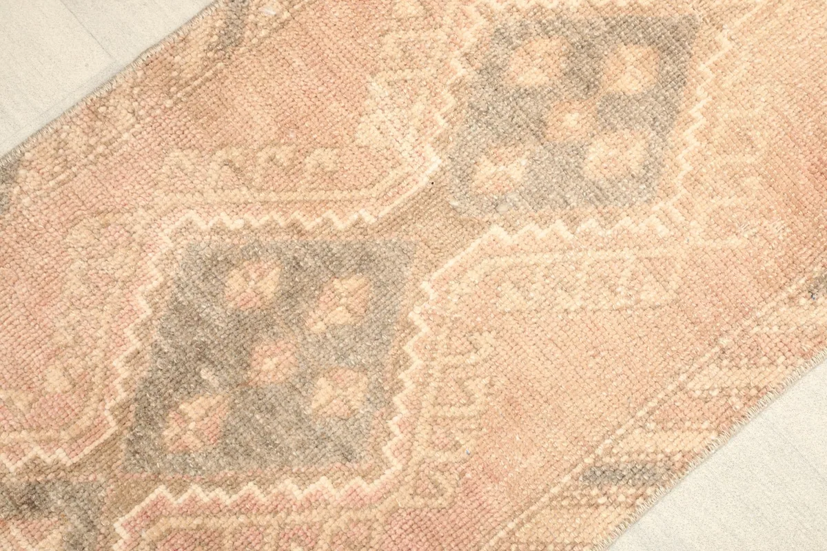 Angled view highlighting the rose field and gray central geometric motifs