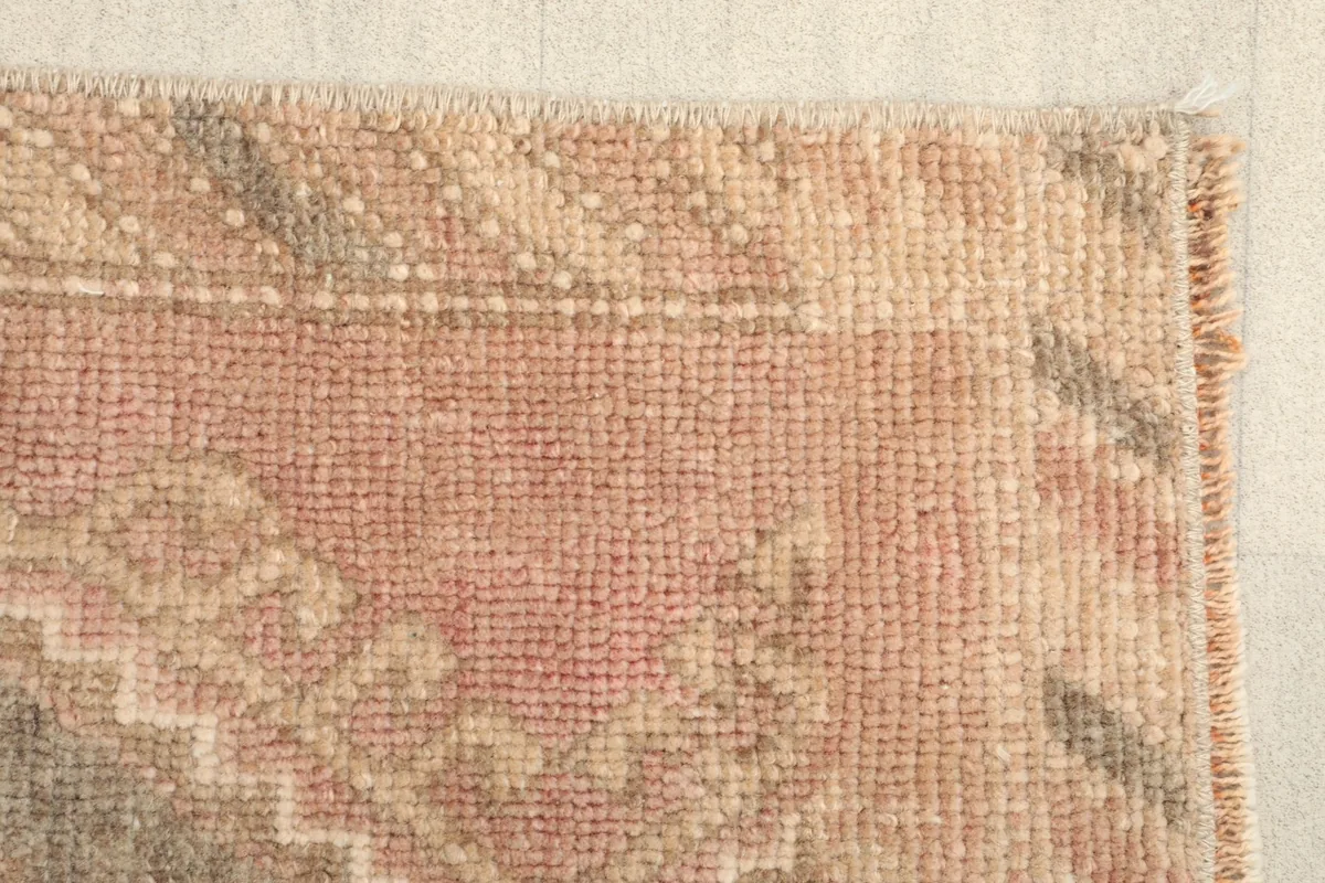 Detail of the rug's edge, showing the tight weave and a hint of the fringe