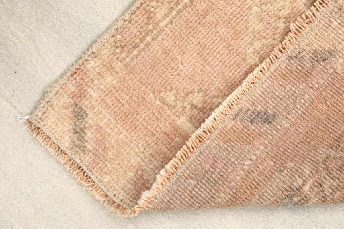 Rug folded to show the texture and thickness of the vintage wool pile