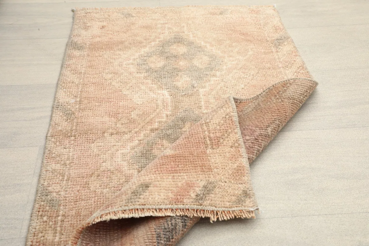 Partially folded rug revealing the back and showing its flexibility