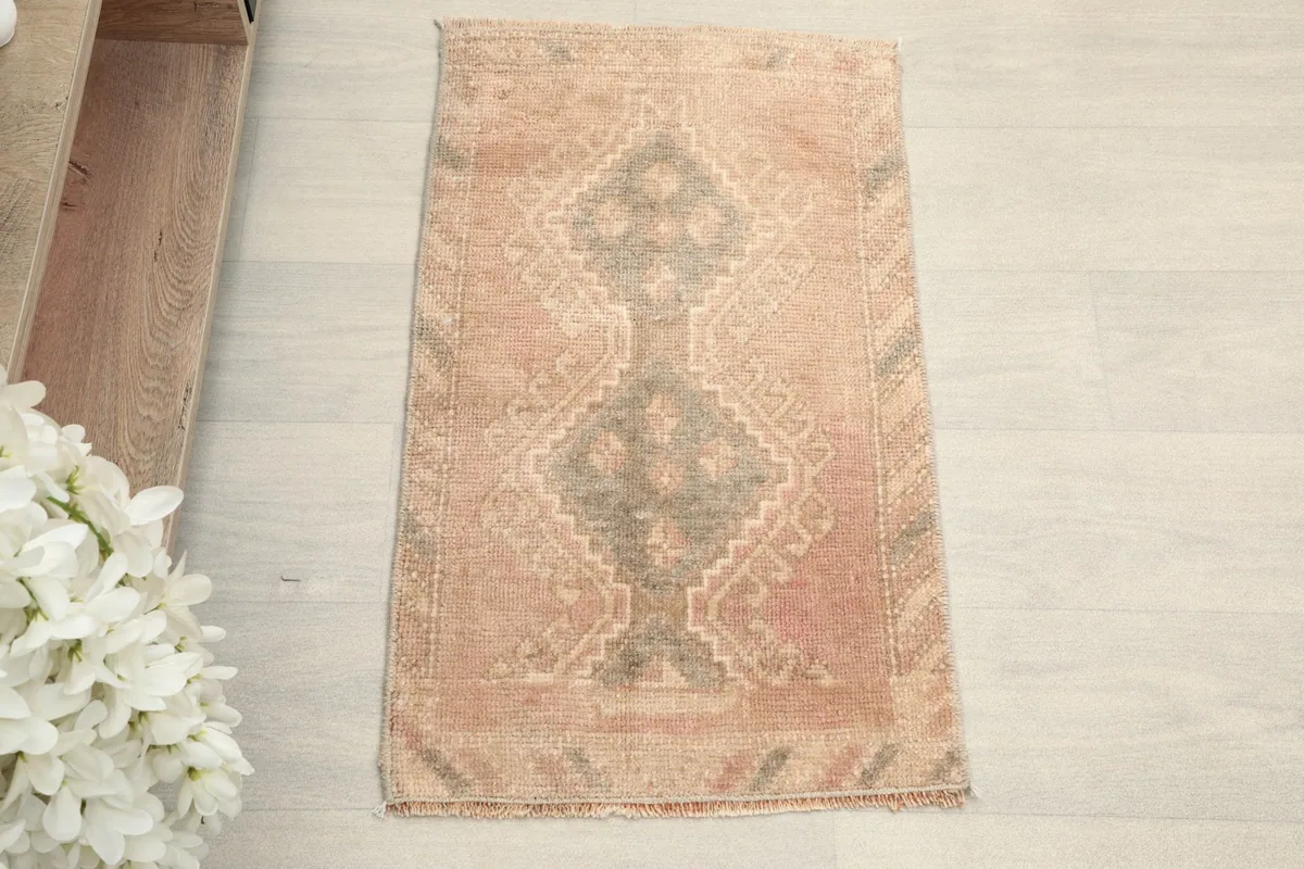 Overhead view of the rose and gray tribal geometric rug
