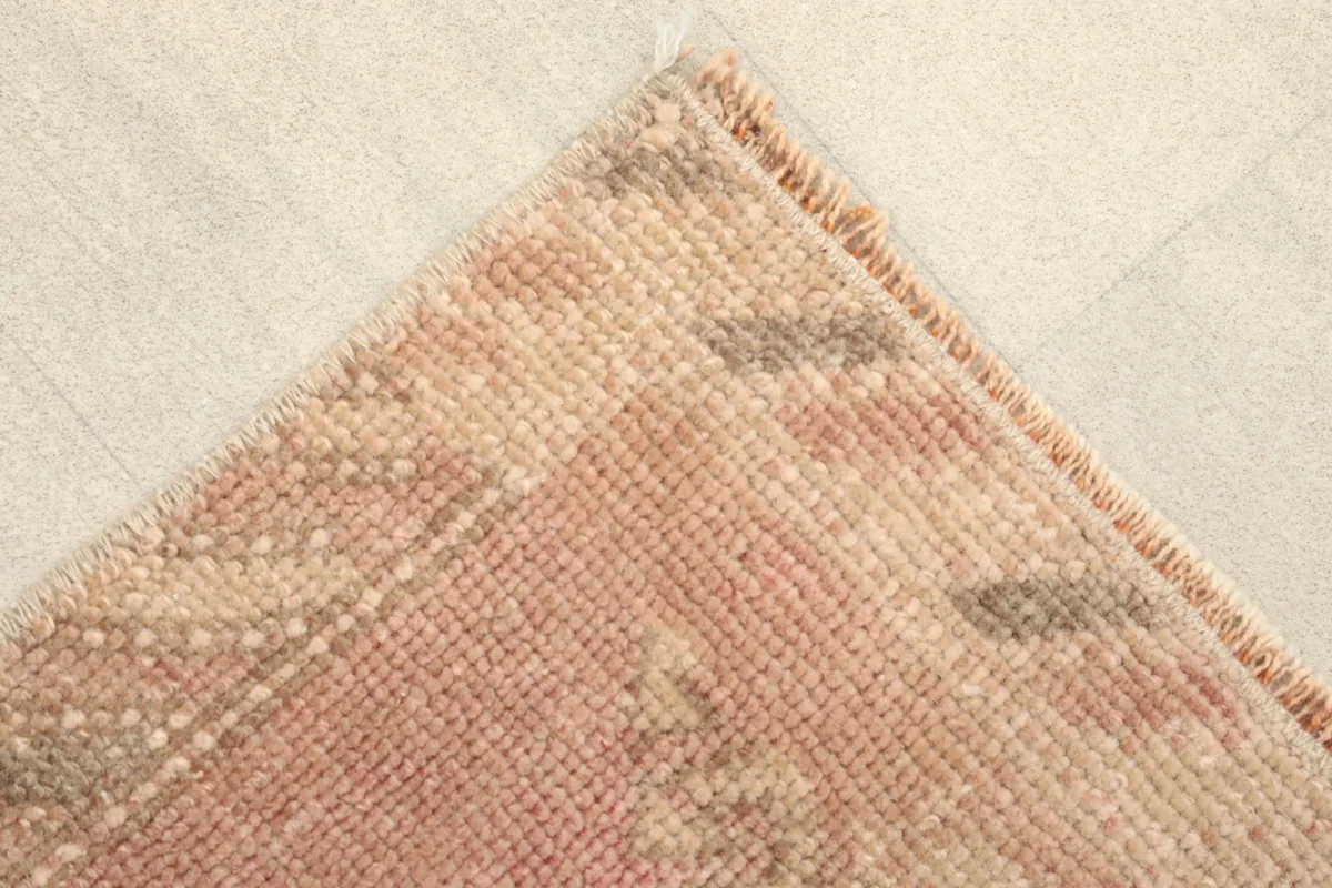 Close-up of a corner, showing the hand-knotted wool pile texture and color variation