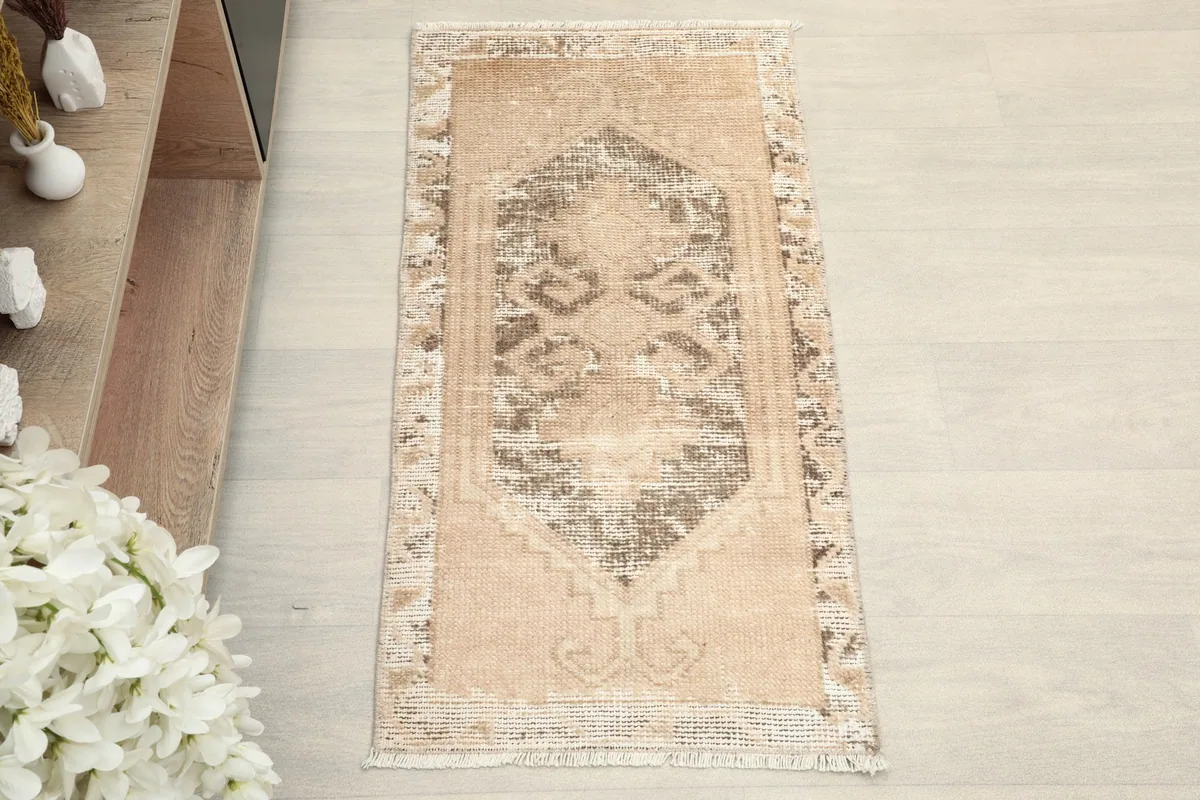 Full top view of the lighter, distressed side of the rug in a room setting.