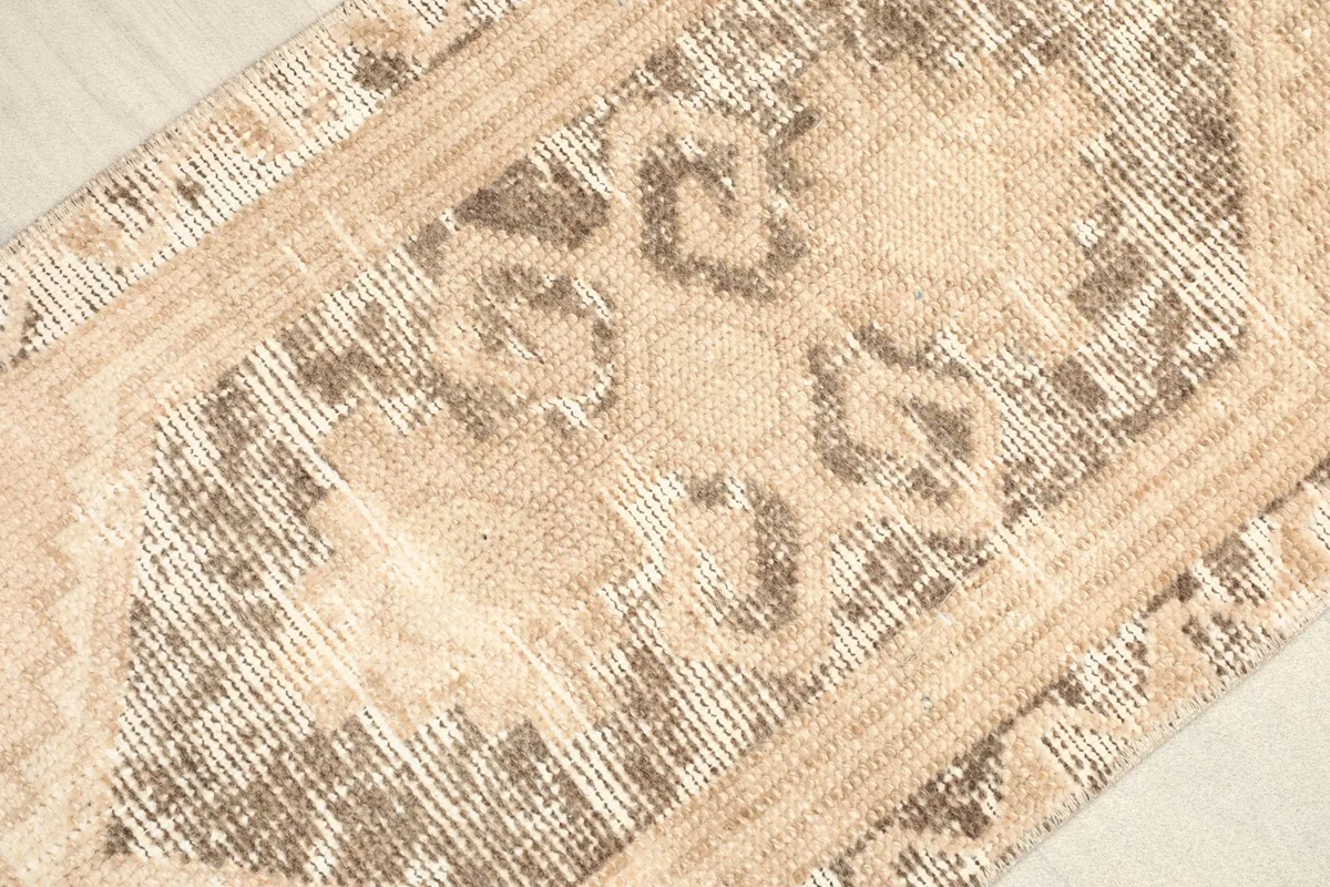 Overhead view of the distressed side, showing faded brown and beige tones.