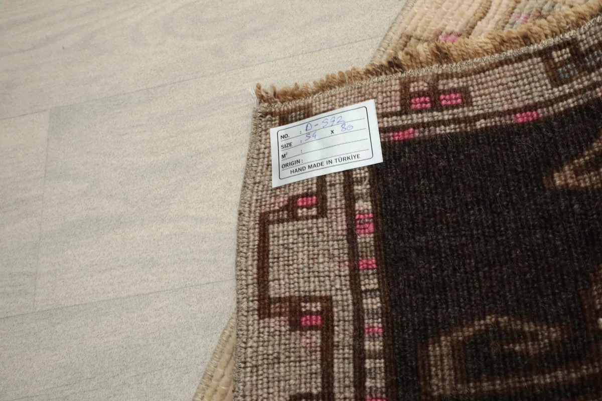 Close-up of the rug's label, indicating hand-made in Turkey.