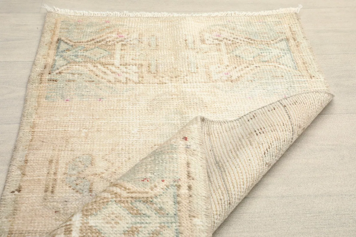 Partial view of the rug's back, showing the consistent hand-knotted structure and fringes.