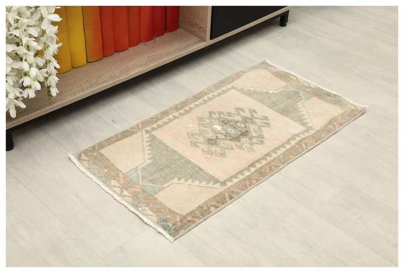 Full top view of the beige and green vintage Anatolian doormat