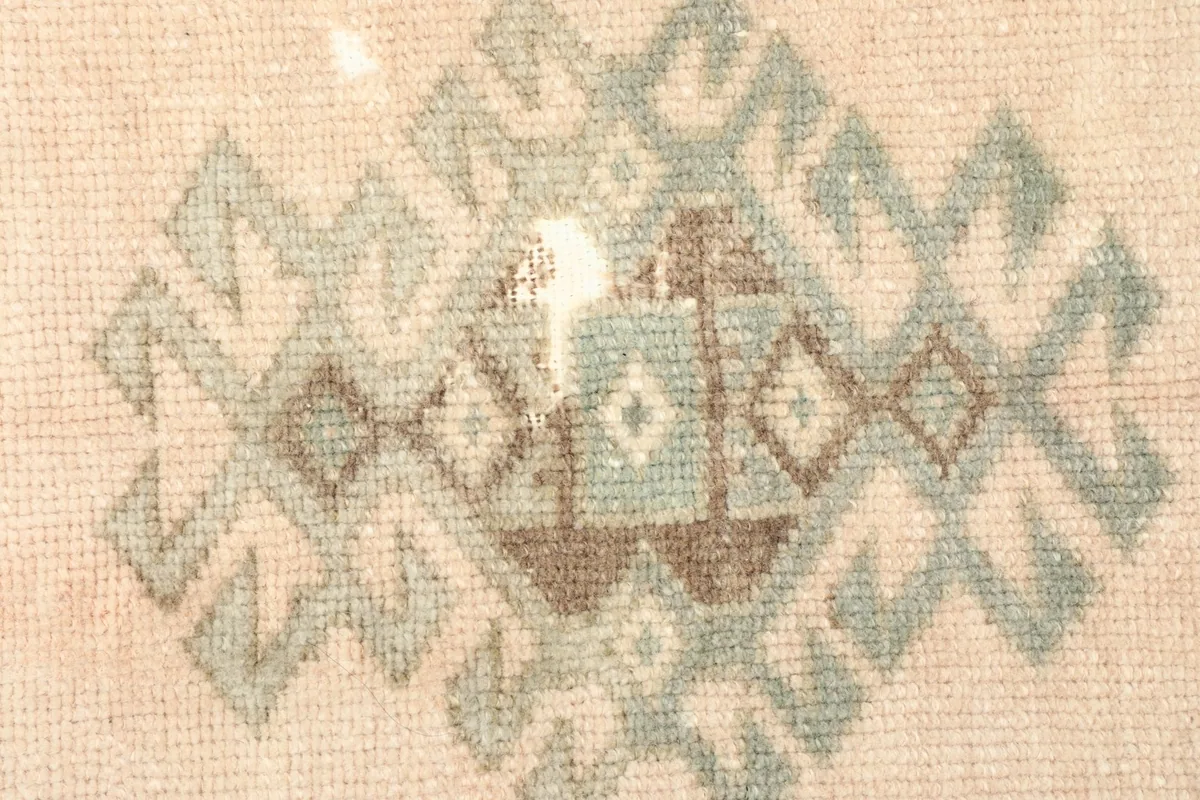 Detailed view of the hand-knotted wool pile and tribal patterns