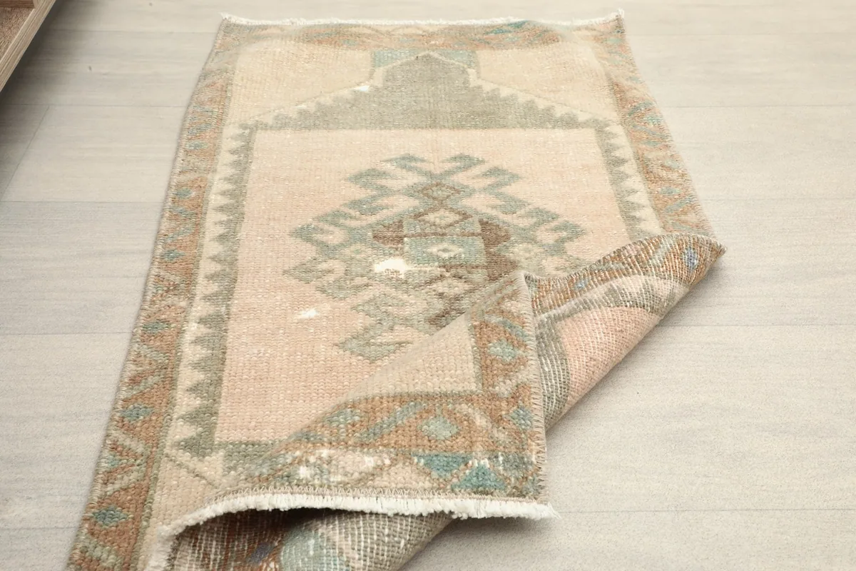 The doormat partially folded, illustrating its flexibility and construction