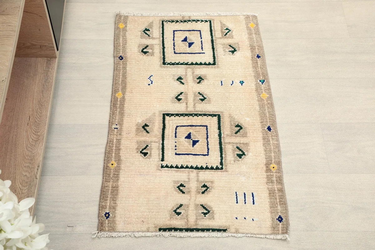 Overhead view of the beige and navy geometric hand-knotted wool rug, showcasing its patterns.