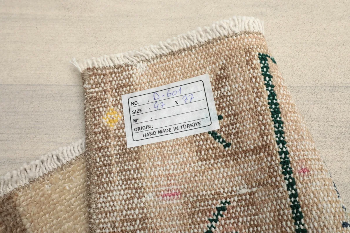 Close-up of the rug's label, confirming its origin and hand-made nature from Turkey.