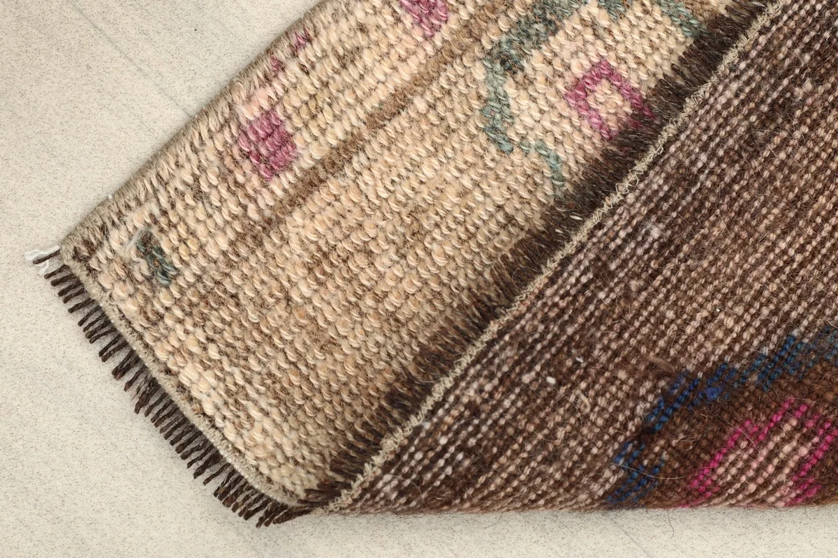 Folded view of the rug showing the cotton foundation and the reverse side of the knotting.