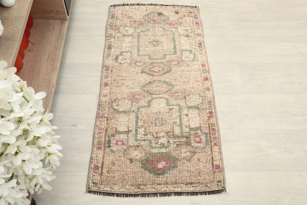 Overhead view of the beige doormat, highlighting its full pattern and shape.
