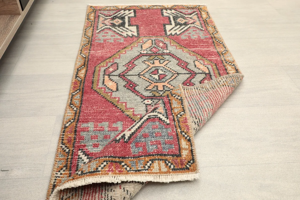 The doormat partially folded, showing its flexibility and full design in a room setting.