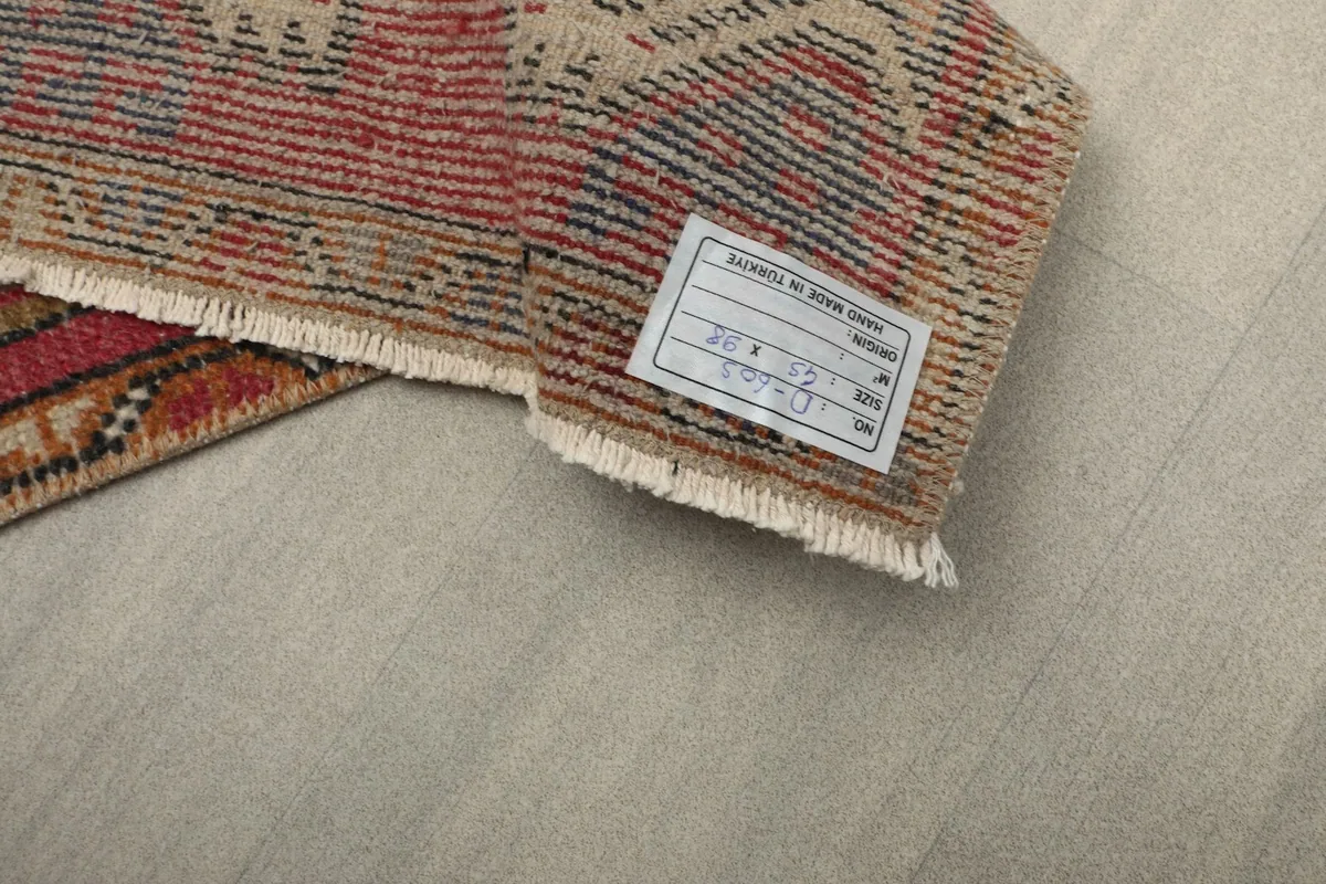 Close-up of the rug's hand-knotted cotton foundation and label on the back.