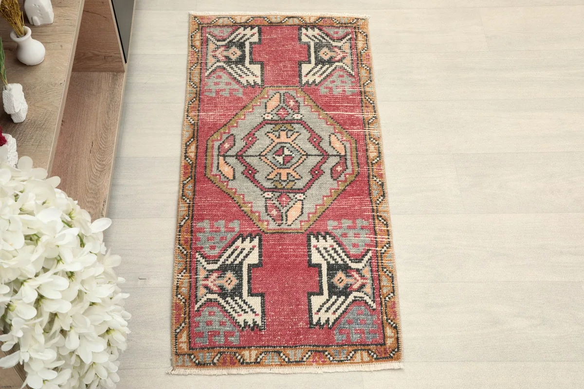 Overhead view showcasing the intricate tribal patterns and rose field of the rug.