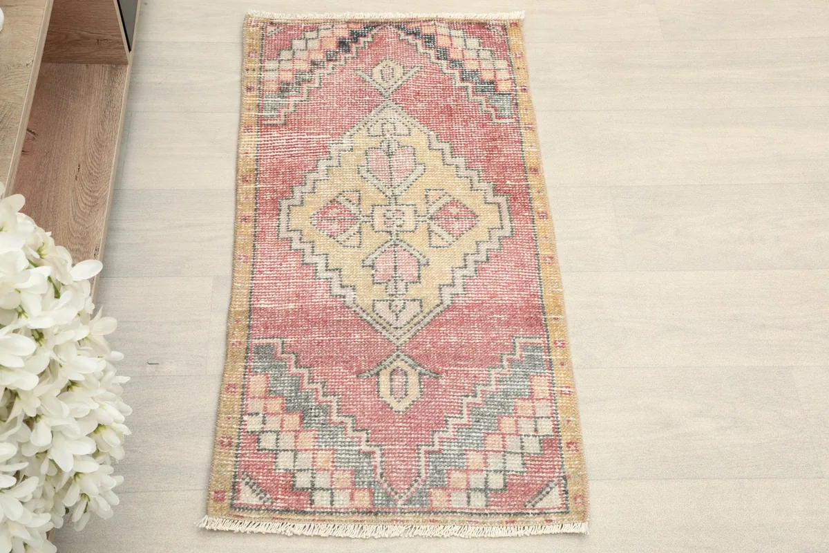 Overhead view showcasing the full geometric pattern of the rose and gold vintage rug.