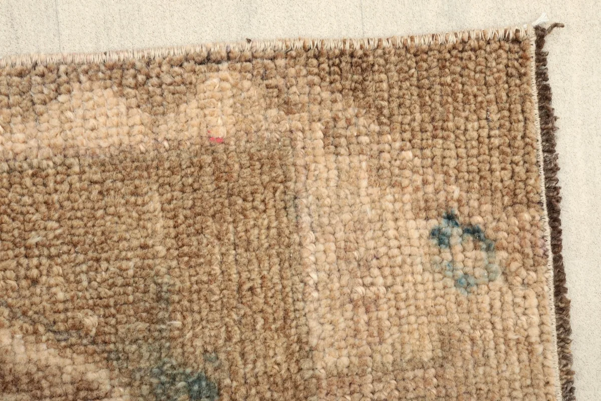 Close-up of the low wool pile, showing the texture and subtle color shifts in the rug.