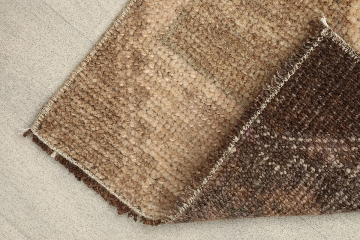 View of the back of the rug, revealing the cotton foundation and hand-knotted construction.