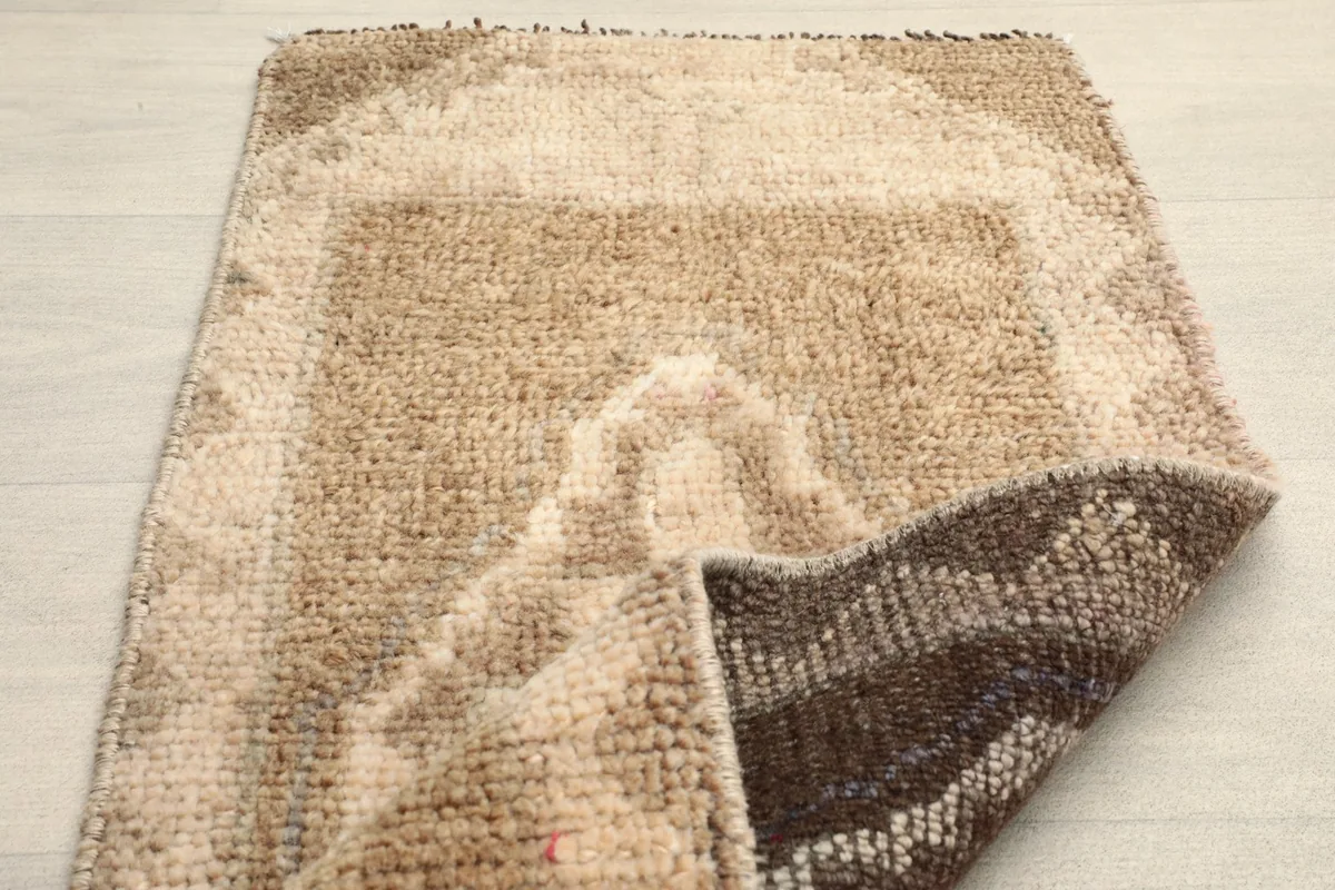 A section of the rug folded to show the thickness and the reverse side’s weave.