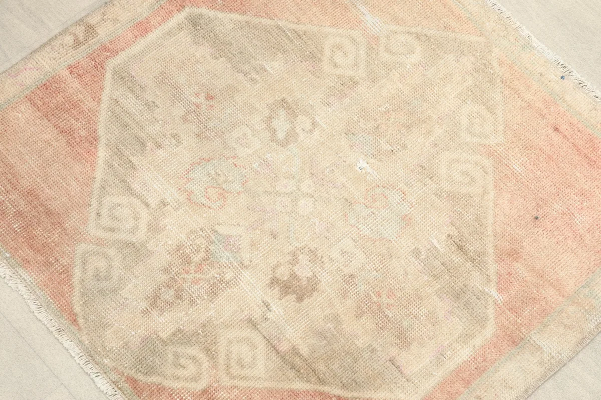 Close-up of the central ivory medallion with subtle geometric and floral elements