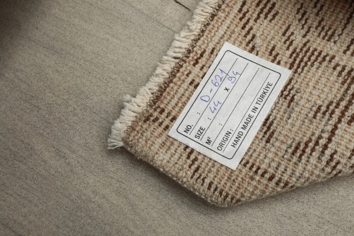 Label on the back of the rug indicating its origin from Turkey and dimensions