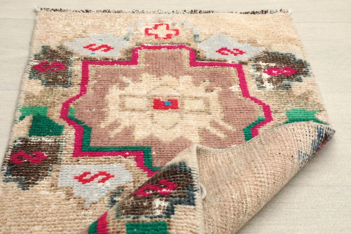 Another folded view showing the texture of the wool pile and the cotton foundation beneath.