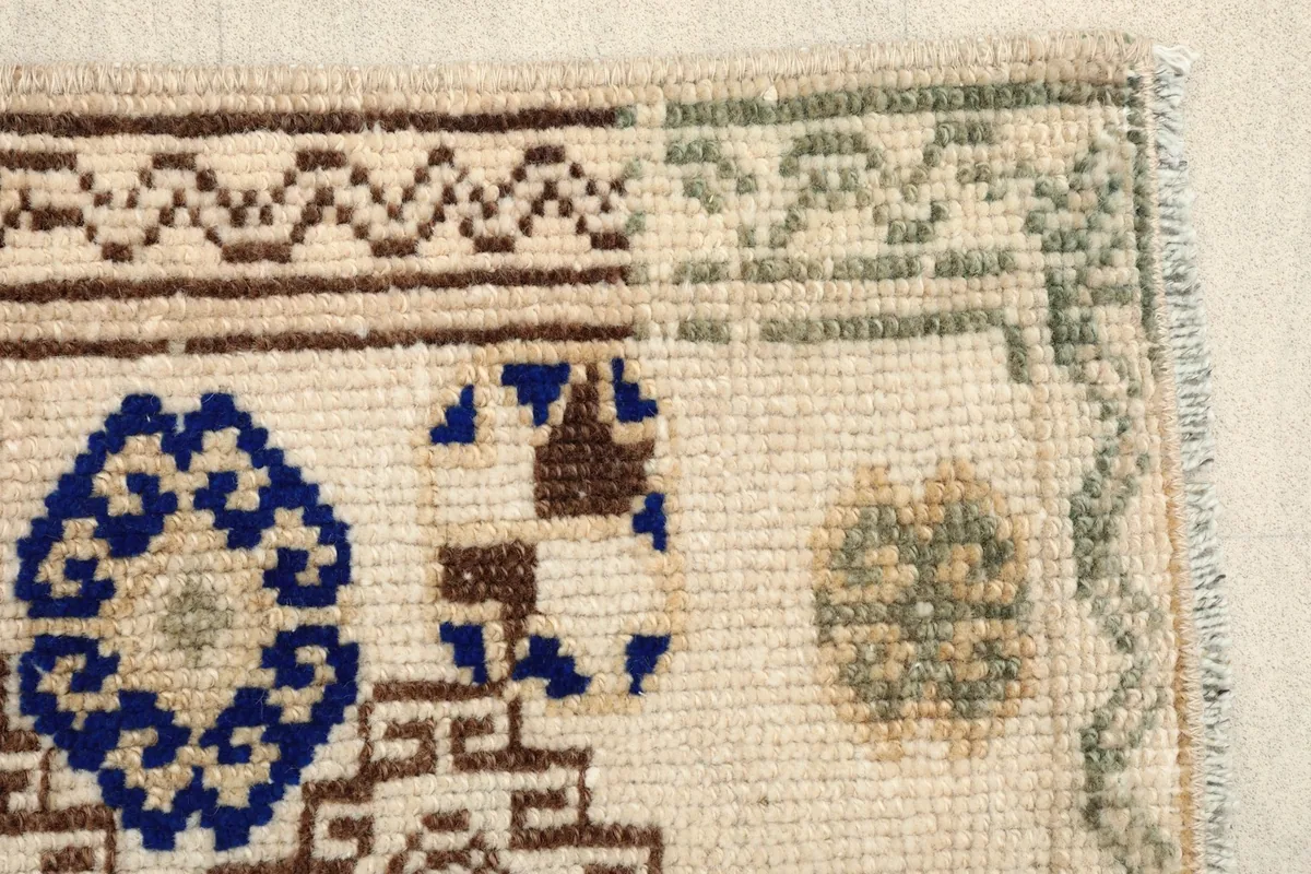Detailed view of the rug's edge, revealing the intricate patterns and knotting.