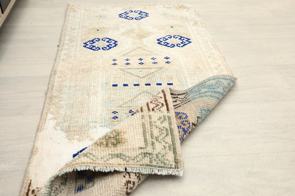 Another angled view with a folded corner, emphasizing the rug's construction and slight patina.