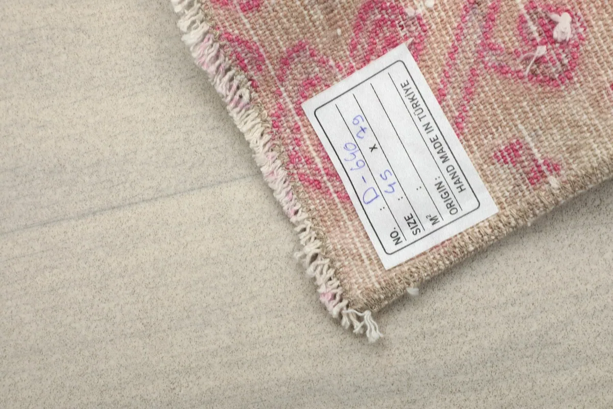 Close-up of the label on the back of the rug, indicating origin from Turkey and dimensions.