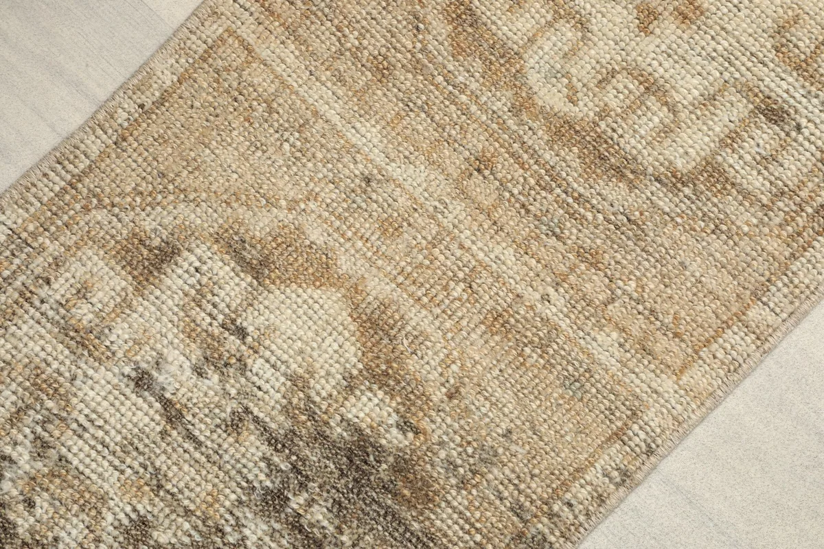 Angled close-up of the rug's surface, highlighting the subtle tribal geometric patterns
