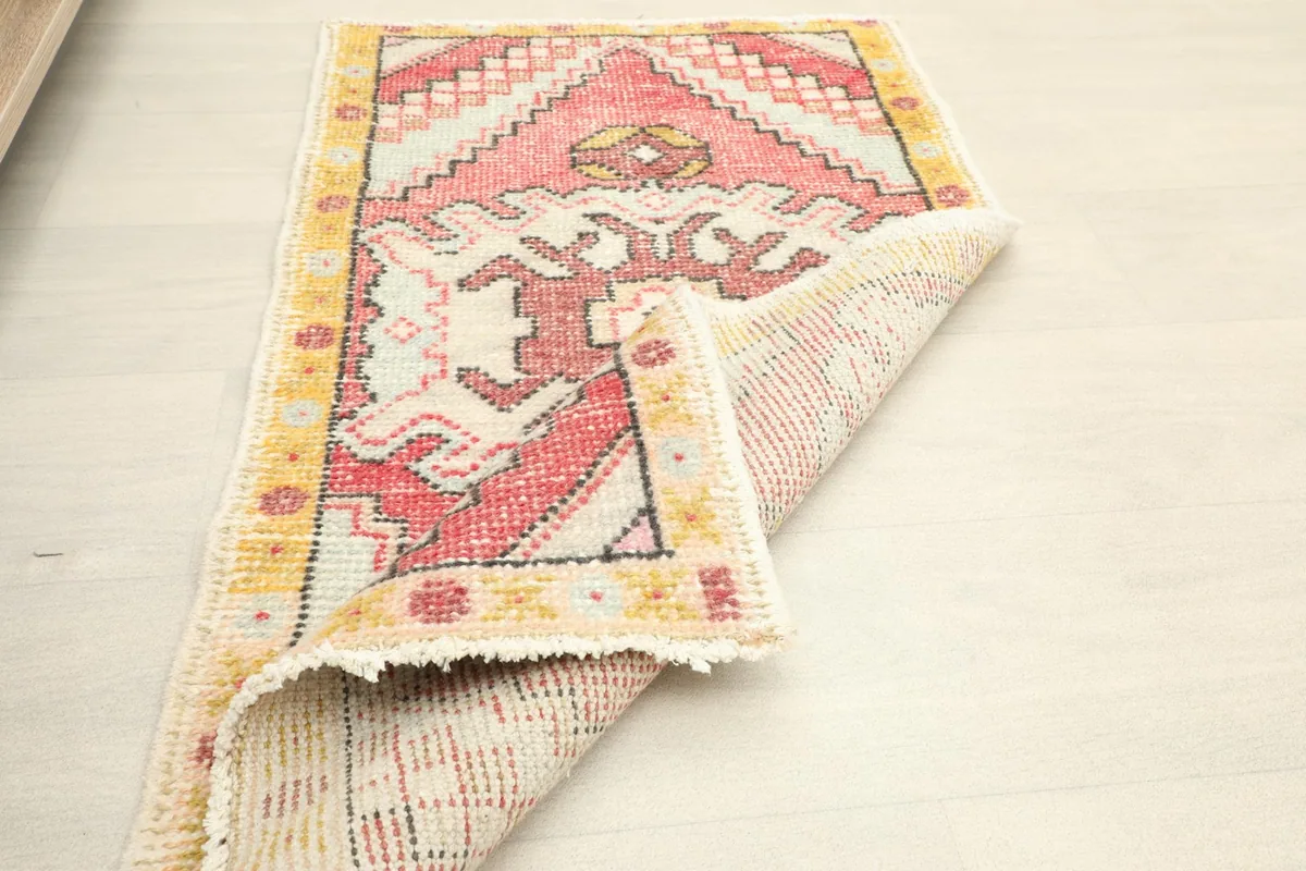 The rug partially folded, illustrating its flexibility and the texture of the reverse side.