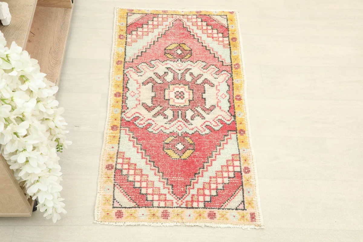 Overhead view of the vintage Anatolian rug, showing its complete geometric design and colors.