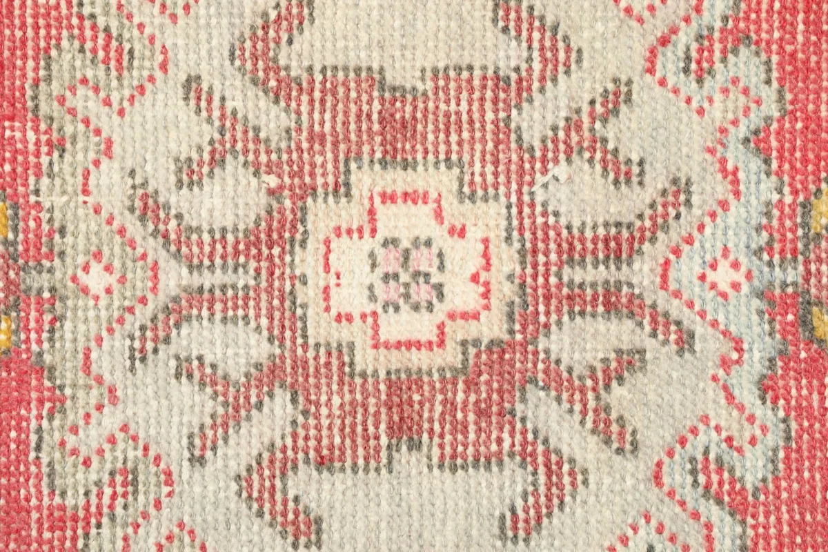 Close-up detail of the central geometric medallion and tribal patterns