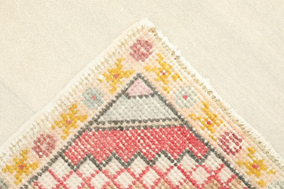 Corner detail of the rug showing the subtle border design and color variations