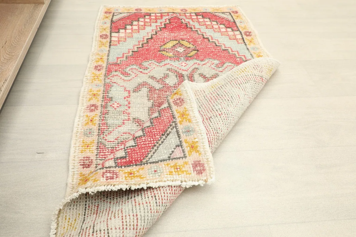 Partially folded small rug, showing the texture and construction