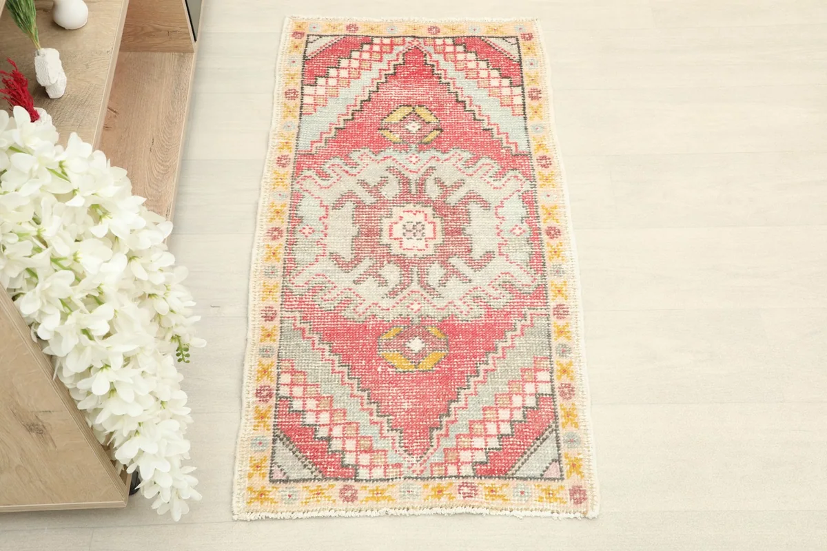 Overhead view of the small hand-knotted rug showing its full pattern and colors