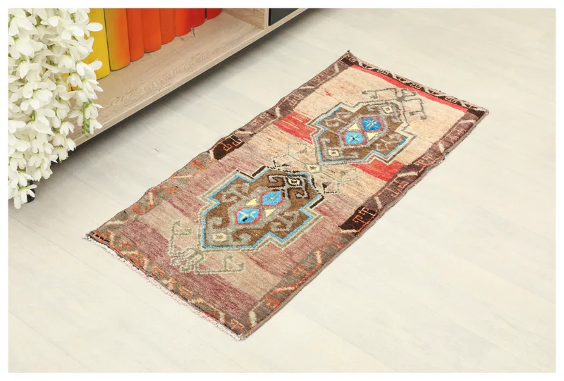 Full top view of the beige and brown vintage Anatolian doormat on a white background.