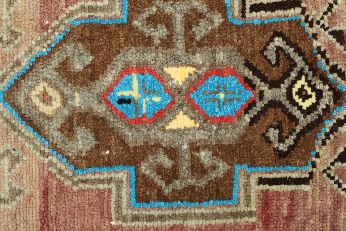 Macro detail of the knotting and colors within one of the geometric patterns.