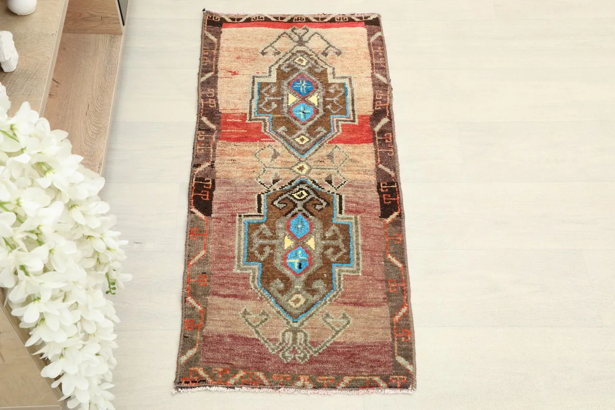 Overhead view of the hand-knotted doormat, showing its geometric tribal pattern.