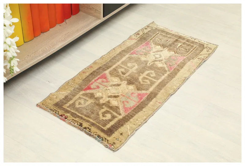 Full top view of the 1'5" x 3'0" brown and tan vintage Anatolian doormat on a light floor.